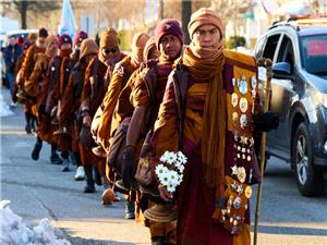`We just need something positive` - Monks` peace walk across US draws large crowds